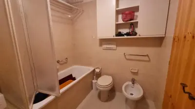 a bathroom with a tub and a toilet and a sink at Col Rodella - Canazei in Canazei