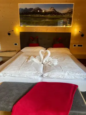 a bed with two swans made out of towels at Villa Anita San Vigilio di Marebbe in San Vigilio Di Marebbe