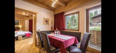 a dining room with a table and chairs and a window at Villa Anita San Vigilio di Marebbe in San Vigilio Di Marebbe