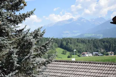 a view of a mountain range from a roof at Pension Hofer in Brunico