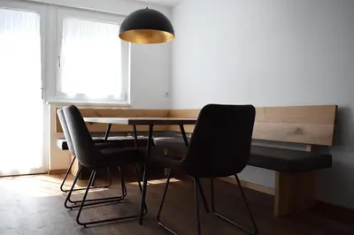 a dining room with a table and chairs at Pension Hofer in Brunico