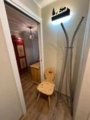 a television on a wooden cabinet in a living room at Case Vacanza Marco - Apt 115 in San Martino di Castrozza