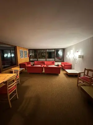 a bedroom with a red cabinet and a bed at Case Vacanza Marco - Apt 115 in San Martino di Castrozza