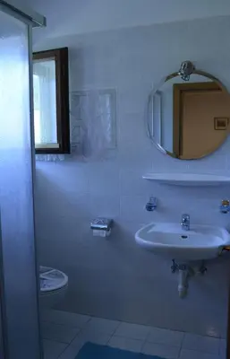 a bathroom with a sink and a mirror at Ferienwohnung Winklerhof in Lana