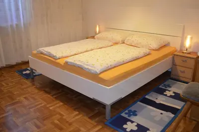 a bedroom with a bed with two candles on it at Ferienwohnung Winklerhof in Lana