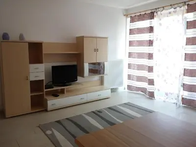 a living room with a flat screen tv on a cabinet at Ferienwohnung Winklerhof in Lana