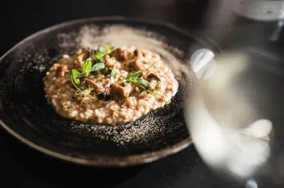 a bowl of food on a plate on a table at Hotel Chalet Dolomites in Alpe di Siusi
