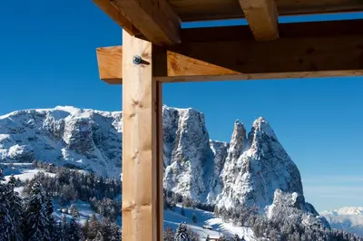 a view of the mountains from a cabin window at Hotel Chalet Dolomites in Alpe di Siusi