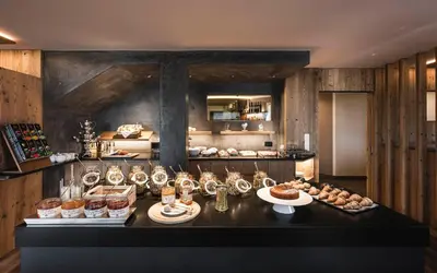 a kitchen with a table with food on it at Hotel Chalet Dolomites in Alpe di Siusi