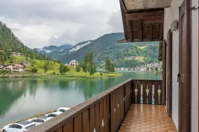 a balcony of a house with a view of a lake at Condominio al Lago in Alleghe