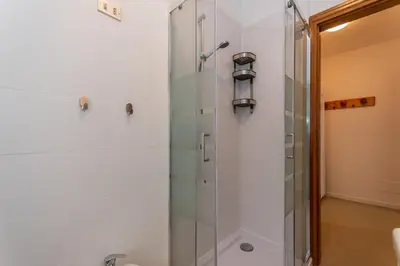 a shower with a glass door in a bathroom at Condominio al Lago in Alleghe
