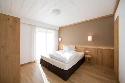 a bedroom with a white bed and a window at Residence Grünwald in San Martino