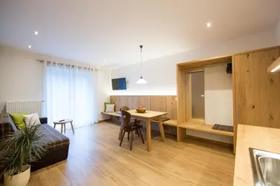 a living room with a table and a dining room at Residence Grünwald in San Martino