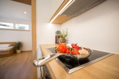 a bowl of vegetables on a stove in a kitchen at Residence Grünwald in San Martino