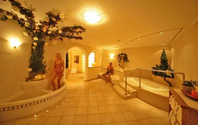 a bathroom with two people sitting in the tub at Appartement Garden in Valdaora