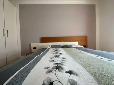 a bedroom with a bed with a blanket on it at Pippi Home in Castello di Fiemme