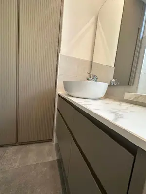 a bathroom with a sink and a mirror at Pippi Home in Castello di Fiemme