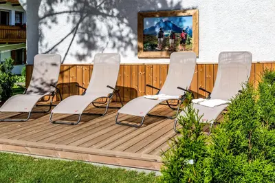 a group of chairs sitting on a deck at Appartements Steiner in Valdaora