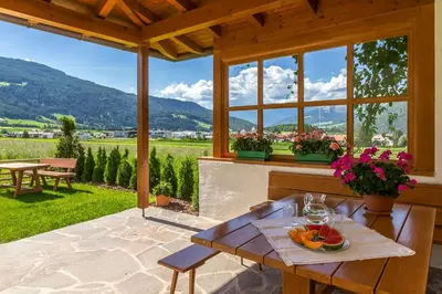 a patio with a table with fruit on it at Appartements Steiner in Valdaora
