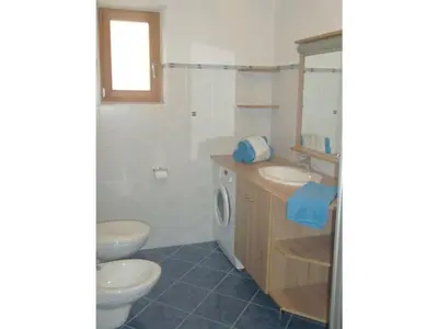 a bathroom with two toilets and a sink and a mirror at Parleitnerhof Ferienwohnung Abendrot in Mühlbach