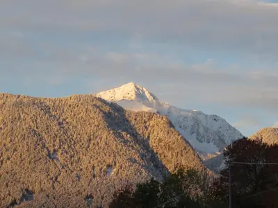 a mountain with snow on top of it at Parleitnerhof Ferienwohnung Abendrot in Mühlbach