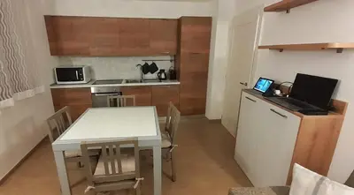 a small bedroom with a bed and a night stand at Alessio House in Pozza di Fassa