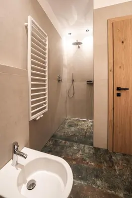 a bathroom with a white sink and a shower at Aparthotel Zum Schlössl in Villa Ottone