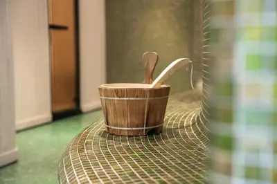 a wooden cup with a wooden spoon sitting on a table at Aparthotel Zum Schlössl in Villa Ottone
