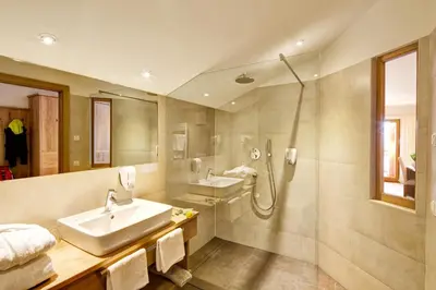a bathroom with a sink and a shower at Hotel Gasthof Kircher in Fiè