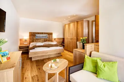 a hotel room with a bed and a table at Hotel Gasthof Kircher in Fiè
