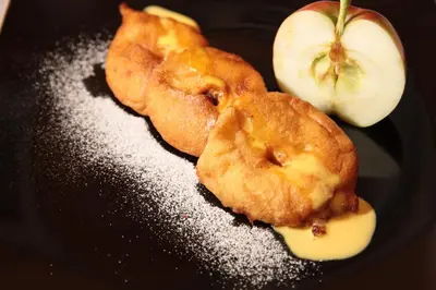 a plate of food with an apple on it at Hotel Gasthof Kircher in Fiè