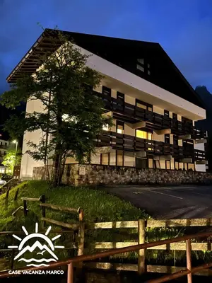 a building with a fence in front of it at Case Vacanza Marco - Junior Suite 116 in San Martino di Castrozza