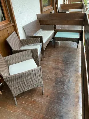 a living room with red couches and tables and windows at Case Vacanza Marco - Junior Suite 116 in San Martino di Castrozza