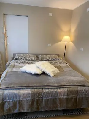 a bedroom with a bed and a desk with a table at Case Vacanza Marco - Junior Suite 116 in San Martino di Castrozza