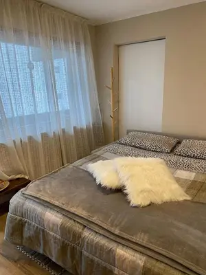 a bedroom with a bed with a large window at Case Vacanza Marco - Junior Suite 116 in San Martino di Castrozza
