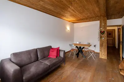 a living room with a couch and a table at Estate in montagna in San Vito di Cadore