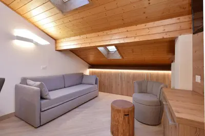 a living room with a couch and a table at Appartamenti Maria in Canazei