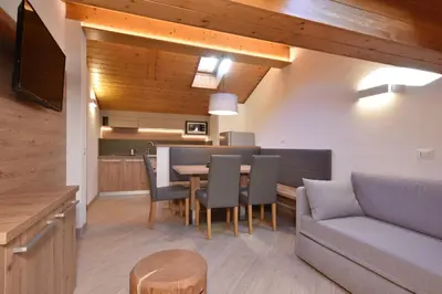 a living room with a couch and a table at Appartamenti Maria in Canazei