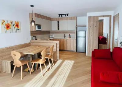 a kitchen with wooden cabinets and a sink at Appartamenti Maria in Canazei