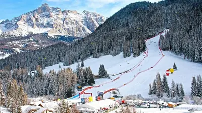 a snow covered mountain with a ski slope with people on it at Apartments Brunella in La Villa