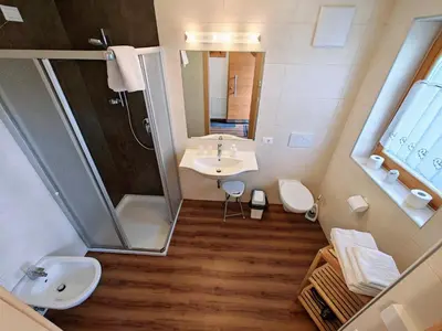 a small bathroom with a sink and a shower at Apartments Brunella in La Villa