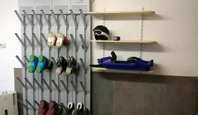 a room with a bunch of shoes on a wall at Apartments Brunella in La Villa