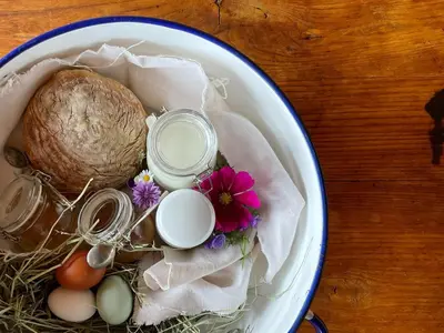 a bowl with eggs and a coconut and flowers on a table at Schallerhof Sterzing - Deine Auszeit mit Ausblick in unseren Ferienwohnungen auf dem Bergbauernhof in Südtirol in Vipiteno