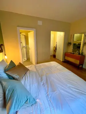 a large white bed with pillows in a bedroom at Brunico 20 in Brunico
