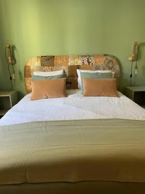 a bedroom with a large bed with two pillows at Brunico 20 in Brunico