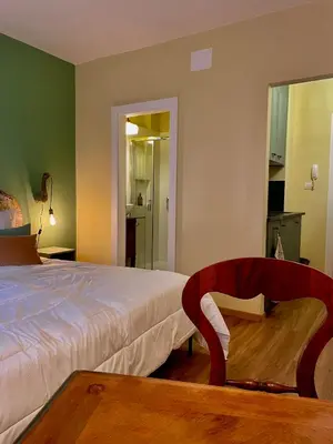 a bedroom with a bed and a table and a chair at Brunico 20 in Brunico
