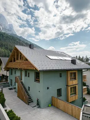 a house with solar panels on top of it at Max Green Wood Apartments in Siusi