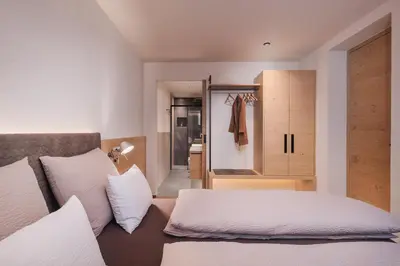 a bedroom with a bed and a closet at Max Green Wood Apartments in Siusi