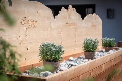 a wooden wall with three potted plants on it at Mountain Caravan - Zirben Nestl in Nova Ponente