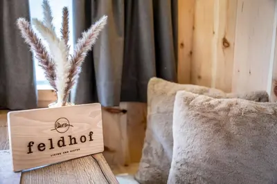 a sign sitting on a table next to a pillow at Mountain Caravan - Zirben Nestl in Nova Ponente